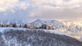 Panorama Picturesque Wasatch Mountains view with houses on a snowy setting in winter