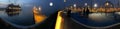 Panorama promenade in harbor cruise ship people relaxing in park blue fogy cloudy night sky with big moon street lantern blurred l