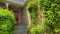 Panorama Plants at the front of the entrance of a house with bricks