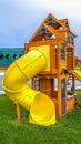 Panorama Playground at the backyard of a home inside a white wooden fence.