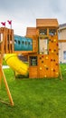 Panorama Playground structure with slide swings playhouse tower and climbing wall Royalty Free Stock Photo