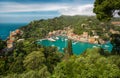 Panorama of Portofino town with multicolored houses and villas, sea and harbor bay with fishing boats and luxury yachts