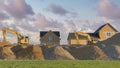 Panorama Puffy clouds at sunset Construction sand piles with two excavators at Utah