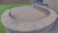 Panorama Puffy clouds at sunset Outdoor patio of a house with curved brick wall and flooring Royalty Free Stock Photo