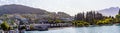 Panorama of Queenstown, Otago, New Zealand with hillside houses rising from the shores of lake Wakatipu.