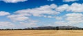 panorama of recently harvested fields with the Grampians mountains rising in the distance on the horizon, rural Victoria,