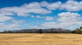 panorama of harvested farm fields with the Grampians mountains rising in the distance on the horizon, rural Victoria,