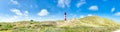 Panorama - red white lighthouse on the north sea Royalty Free Stock Photo