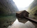 Panorama reflection of old wooden boat house shed alpine mountain lake Obersee Koenigssee Berchtesgaden Bavaria Germany