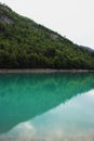 Panorama reflection of turquoise bright blue colored alpine mountain lake reservoir Mapragg Mapraggsee in Switzerland Royalty Free Stock Photo