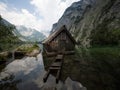 Panorama reflection of wooden boat house shed alpine mountain lake Obersee Fischunkelalm Berchtesgaden Bavaria Germany