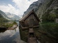 Panorama reflection of wooden boat house shed alpine mountain lake Obersee Fischunkelalm Berchtesgaden Bavaria Germany