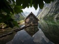 Panorama reflection of wooden boat house shed alpine mountain lake Obersee Fischunkelalm Berchtesgaden Bavaria Germany