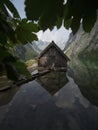 Panorama reflection of wooden boat house shed alpine mountain lake Obersee Fischunkelalm Berchtesgaden Bavaria Germany