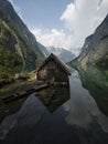 Panorama reflection of wooden boat house shed alpine mountain lake Obersee Fischunkelalm Berchtesgaden Bavaria Germany