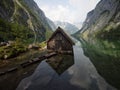 Panorama reflection of wooden boat house shed alpine mountain lake Obersee Fischunkelalm Berchtesgaden Bavaria Germany