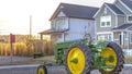 Panorama Replica of a tractor at a park with houses and sky in the background