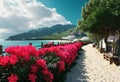 Panorama of the resort with the Sea, wide beach, scarlet oleander bush, wooden fence and lanterns in retro style Royalty Free Stock Photo