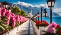 Panorama of the resort with the Sea, wide beach, scarlet oleander bush, wooden fence and lanterns in retro style Royalty Free Stock Photo
