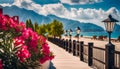 Panorama of the resort with the Sea, wide beach, scarlet oleander bush, wooden fence and lanterns in retro style Royalty Free Stock Photo