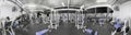 Panorama of a retro bright gym. White sport equipment and blue seats