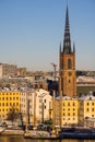 Panorama with Riddarholm Church and colorful houses around on sunny winter day, view from the hilltop.