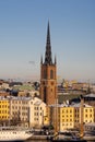 Panorama with Riddarholm Church and colorful houses around on sunny winter day, view from the hilltop.