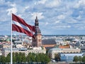 Panorama of Riga city with a big Latvian flag in foreground Royalty Free Stock Photo