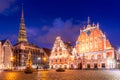 Panorama of Riga Old Town Hall Square, Roland Statue, The Blackheads House and St Peters Cathedral illuminated in the twilight,