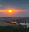 Panorama of the river, fields and forests on the background of a sunset