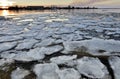 Panorama of river valley with spring ice drifting at sunset
