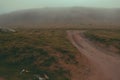 Panorama road after rains in Mountain Foggy Carpathian Mountains peaks on a foggy autumn morning. Bucegi Mountains, Romania Europe Royalty Free Stock Photo