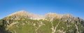 Panorama of rocky mountain range Granaty and Krzyzne pass in Five Polish Ponds Valley in Tatra Mountains, Poland Royalty Free Stock Photo