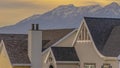 Panorama Roofs of houses with a striking mountain capped with snow in the background