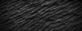 Panorama rough black slate texture background. Panoramic dark black carving slate texture surface