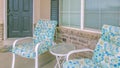 Panorama Round table and colorful chairs in front of the window at the porch of a home