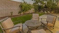 Panorama Round table and cushioned armchairs on the patio of a house