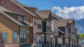 Panorama Row of homes with porches and balcony against mountain and sky on a sunny day Royalty Free Stock Photo