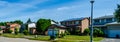 Panorama of a row of residential houses along a street, one with solar panels on the roof Royalty Free Stock Photo