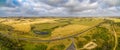 Panorama of rural road passing through pastures.