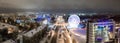 Panorama of the Russian city of Kirov from a height on a winter night. Oktyabrsky Avenue and Ferris Wheel in the New