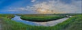 Panorama of salt marsh, mud flat and bridge over marsh channel in Sankt Peter Ording at the SÃÂ¼dstrand. Royalty Free Stock Photo