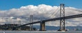 Panorama of the San Francisco bay bridge with fluffy white clouds Royalty Free Stock Photo