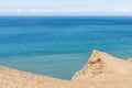 Panorama of sand dunes and blue sea. Seascape with people resting and walking near the sea on a summer day. Royalty Free Stock Photo