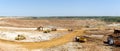 Panorama of the sand quarry. Extraction of sand in the quarry. Backhoe loading sand into dump trucks.