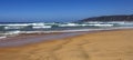 Panorama of a sandy ocean beach with waves and foam Royalty Free Stock Photo