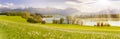 Panorama scene in Bavaria, Germany at alps mountains with sunbeams over lake