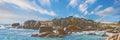 Panorama sea view of Camps Bay, Cape Town, South Africa with boulders, rocks and blue sky with copy space. Oceans waves Royalty Free Stock Photo