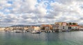 A panorama of the seaport town Chania, the island of Crete, Greece. A harbor with wooden pantons, moored yachts, ships, boats. Royalty Free Stock Photo