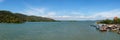 Panorama seascape view of old wooden house and fishing boat in community.